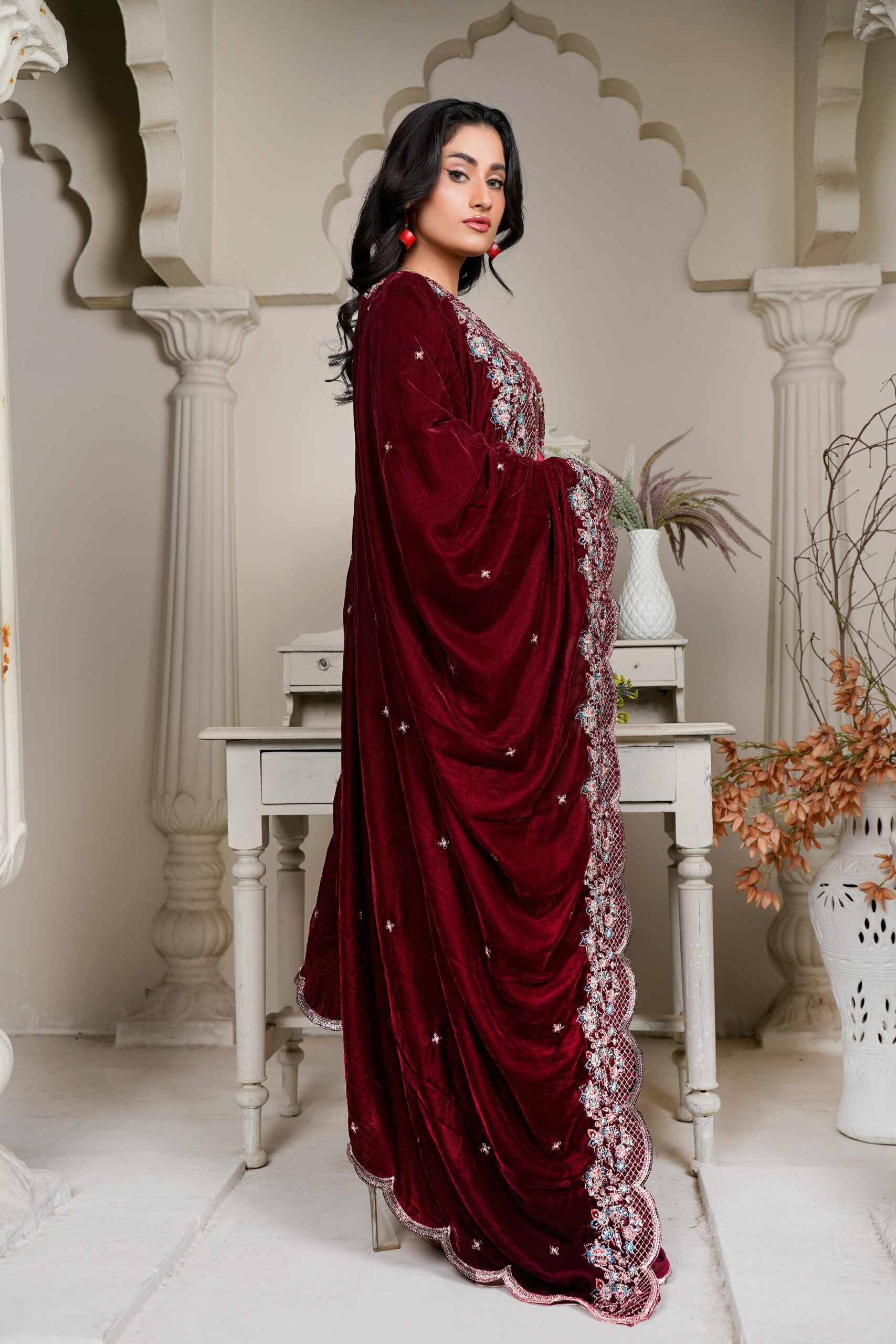 Stunning portrait of a model in a rich velvet dress at a Lahore photoshoot.